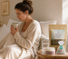 Woman drinking herbal tea and water while learning about natural UTI healing support and warning signs
